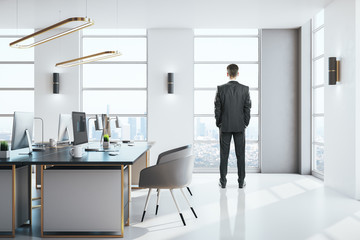 Canvas Print - Businessman standing in modern office interior