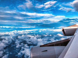 Wall Mural - flying airplane, wing and engine above the sky. travel concept