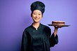 © Krakenimages.com - Young chinese chef woman wearing cooker uniform and hat holding tray with cake with a happy face standing and smiling with a confident smile showing teeth