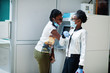 © AS Photo Family - Two african womans wearing disposable medical mask and gloves near atm cash during coronavirus pandemia outbreak. Epidemic time.
