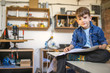 © Stock Rocket - Cute Boy Reading Instructions How To Make Birdhouse