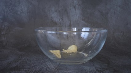 Wall Mural - Stop Motion Animation of Chips Disappearing from a Glass Bowl