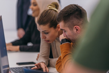 young business colleagues working together on a computer in a comfortable office atmosphere.