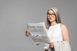 © LIGHTFIELD STUDIOS - beautiful asian businesswoman in eyeglasses reading business newspaper isolated on grey