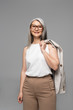 © LIGHTFIELD STUDIOS - beautiful smiling asian businesswoman in eyeglasses isolated on grey