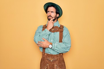 Young handsome man wearing tratidional german octoberfest custome for Germany festival Thinking worried about a question, concerned and nervous with hand on chin