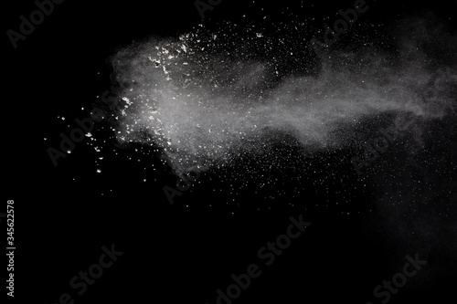 Cuadros en Lienzo Freeze motion of white dust particles splash on black background