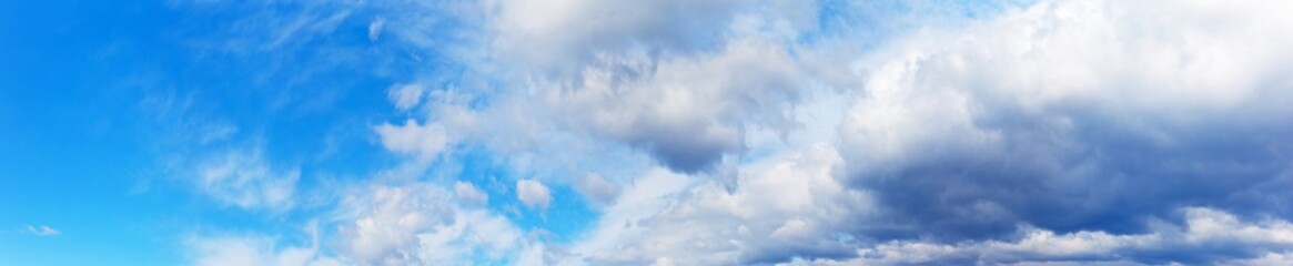 panorama of a blue sky with impending thunderstorm clouds. heaven natural background. banner, blank.