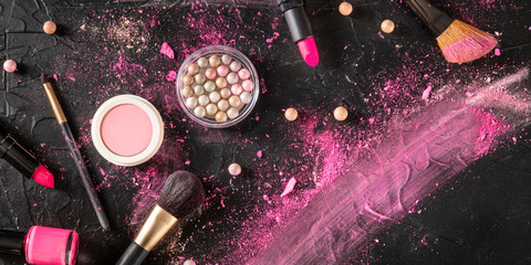 Wall Mural - Professional makeup panorama on a black background. Brushes, lipstick and other products, a flat lay with copy space