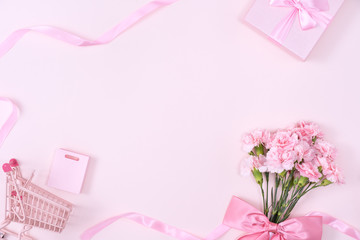 Mother's Day, Valentine's Day background design concept, beautiful pink carnation flower bouquet on pastel pink table, top view, flat lay, copy space.