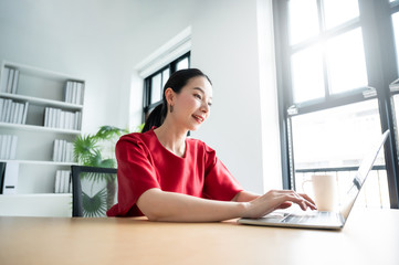 Work at home, Video conference, Online meeting video call, Portrait of beautiful young asian woman looking at computer screen watching webinar and working on laptop in workplace