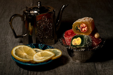 Wall Mural - Still life with slices of Turkish delight and slices of lemon on old wood