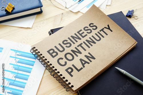 Fotomural BCP Business continuity plan is on the table.