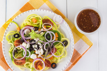 Wall Mural - Spiral zucchini noodles salad with variety vegetables.