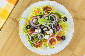 Wall Mural - Spiral zucchini noodles salad with variety vegetables.