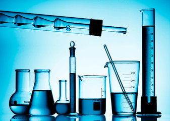 Poster - Different laboratory glassware with color liquid and with reflection