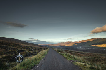 Wall Mural - Rural Road Across Scottish Highlands at Sunset