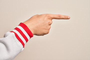 Hand of caucasian young man showing fingers over isolated white background pointing with index finger to the side, suggesting and selecting a choice