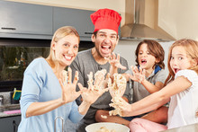 Parents And Children Silly Kneading Around While Kneading Dough