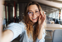 Image Of Happy Woman In Eyeglasses Laughing And Taking Selfie Photo