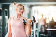 © DJ Creative Studio - Beautiful Caucasian Sport Woman Lifting Dumbbells and Workout Exercises in Gym - Lifestyle and Healthcare Concept