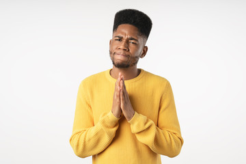 Wall Mural - Handsome african young thoughtful man being in doubt isolated over white background