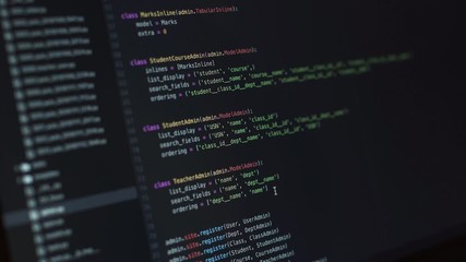 Close-up shot of a display with a programming code being written during pandemic covid-19 coronavirus. People have to work and study from home
