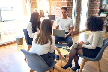 Group of business workers smiling happy and confident. Sitting on chairs relaxed with smile on face. Speaking taking rest at the office