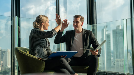 Meeting and discussion concept.business people communicating in office.Mature businessman discuss information with a colleague in a modern business lounge high up in an office tower.