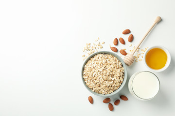 Sticker - Composition with oatmeal flakes on white background, top view. Cooking breakfast