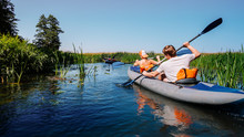 Boating On The River In A Boat. Boating On The River In A Kayak. Boating On The Small Forest River.