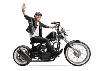 Wall Mural - Elderly biker in leather jacket riding a chopper and waving