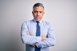 © Krakenimages.com - Middle age handsome grey-haired business man wearing elegant shirt and tie skeptic and nervous, disapproving expression on face with crossed arms. Negative person.