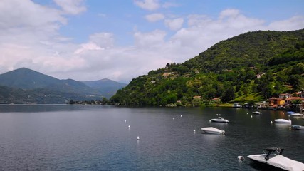 Aufkleber - drone fly above boats on Lake Orta mountains view with green forest summer season in Italy resort