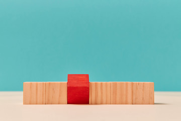 Wooden cubes mockup, copy space. Blank uncolored blocks in line, one red inverted brick. Template for business design