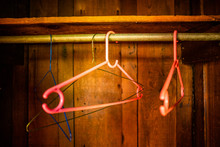 Colorful abstract image of clothing hangers in a wooden closet. 