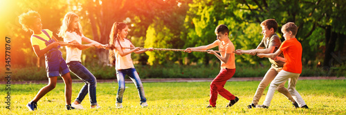 Fotografía Cute little children playing with rope outdoors on sunny day