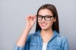© deagreez - Close-up portrait of her she nice attractive lovely charming winsome cheerful cheery content brown-haired girl wearing touching accessory specs isolated over grey pastel color background