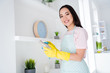 Portrait of her she nice attractive cheerful cheery girl making doing fast professional domestic work wiping things everyday responsibility in modern light white interior kitchen