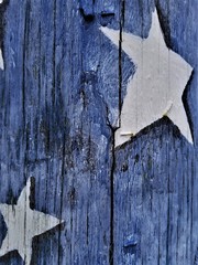  Two White Stars Against Blue Background Painted on Weathered Wood