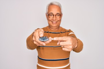 Poster - Middle age senior grey-haired man using tv remote control watching television very happy pointing with hand and finger