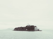 Scenic View Of Sea And Alcatraz Island Against Clear Sky