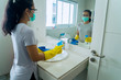© Creativa Images - Young woman cleaning the bathroom with disinfectant
