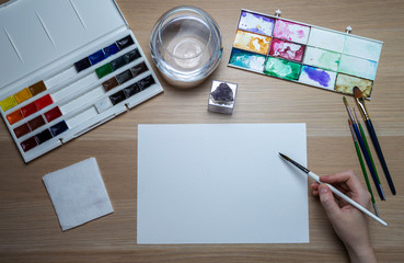 Mockup of the artist's desktop with brushes and paints