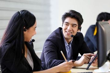 Asia Group of call center workers or Confident business team with headset in office.