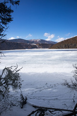 Wall Mural - Potatso National Park or Pudacuo National Park during winter with mountain and frozen lake scenery with snow covered ground