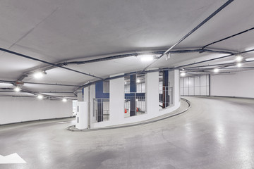 Circular climb to the parking. Underground garage parking. Automobile parking inside.