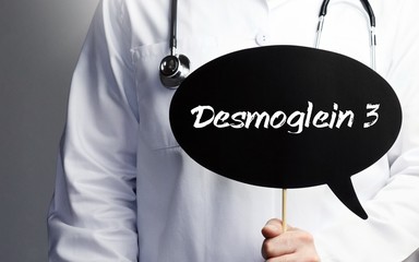 Desmoglein 3. Doctor in smock holds up speech bubble. The term Desmoglein 3 is in the sign. Symbol of illness, health, medicine