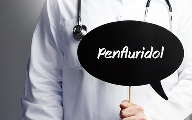 Penfluridol. Doctor in smock holds up speech bubble. The term Penfluridol is in the sign. Symbol of illness, health, medicine