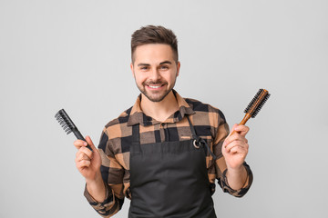 Wall Mural - Male hairdresser on grey background